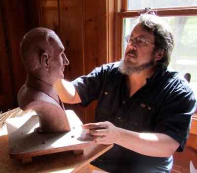 David, working on a portrait bust. David, working on a portrait bust.
