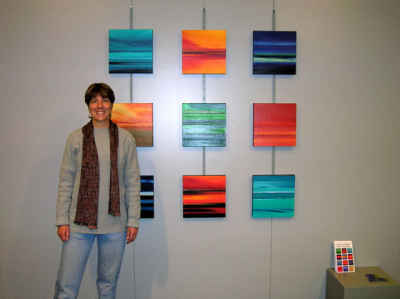 Paula Schoen with her paintings.